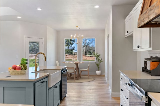 kitchen with pendant lighting, gray cabinets, light countertops, custom range hood, and white cabinetry