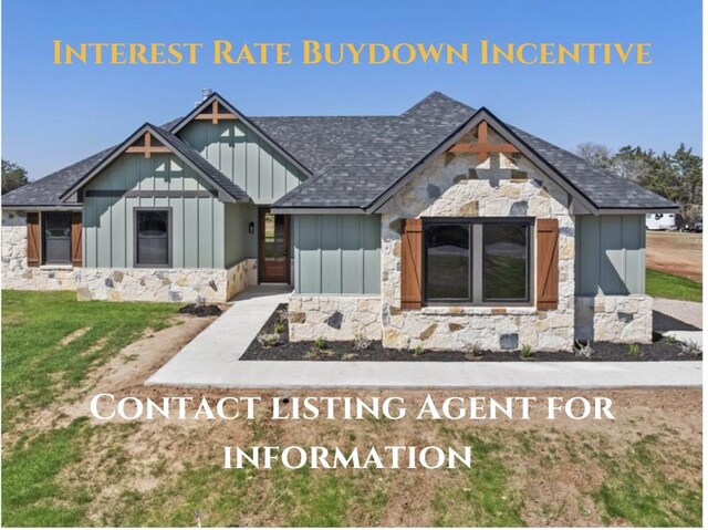 1730 County Road 217, Giddings, TX 78942 - view of front of property featuring board and batten siding, stone siding, roof with shingles, and a front lawn