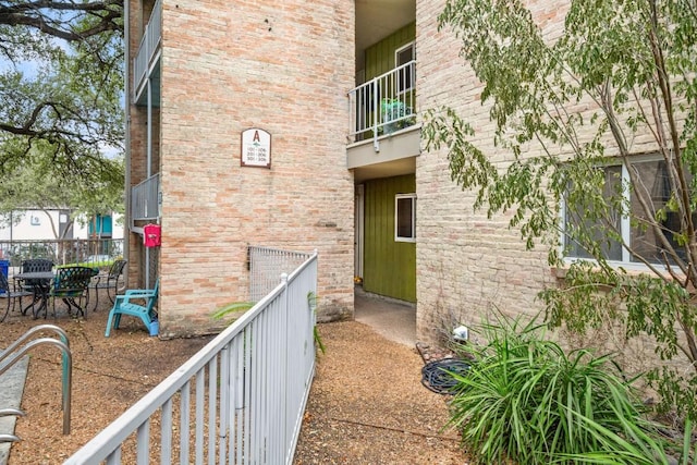 620 S 1st St Unit 104, Austin, TX 78704 - doorway to property featuring a balcony and brick siding