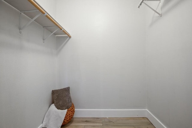 walk in closet featuring wood finished floors