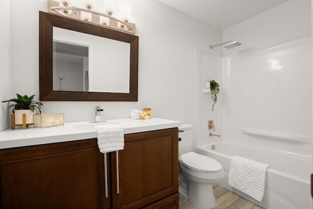 bathroom with toilet, vanity, and bathing tub / shower combination