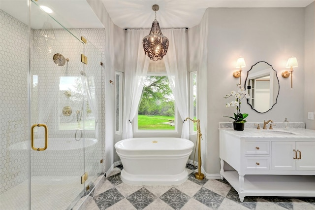 bathroom with a soaking tub, baseboards, a shower stall, and vanity