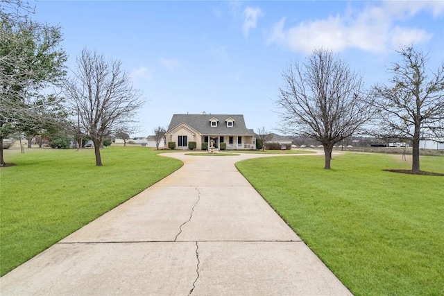 view of front of home featuring concrete driveway and a front yard