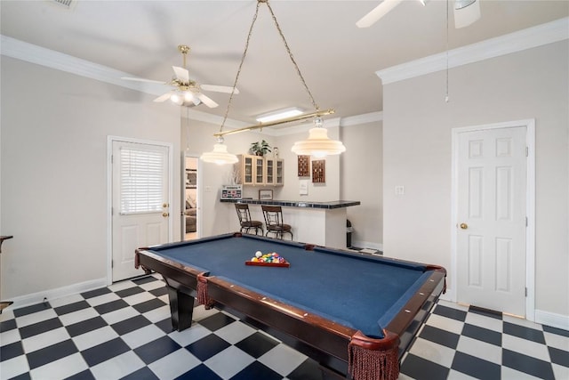 playroom with ceiling fan, dark floors, and ornamental molding