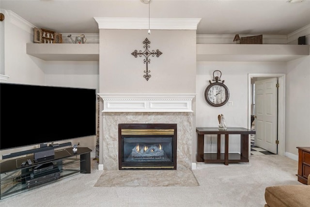 carpeted living area with a high end fireplace, crown molding, and baseboards