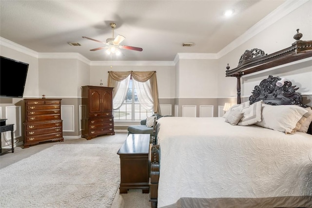 bedroom with light carpet, visible vents, ornamental molding, and a ceiling fan