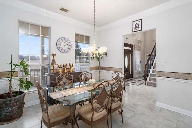 dining area with a healthy amount of sunlight, stairs, visible vents, and crown molding