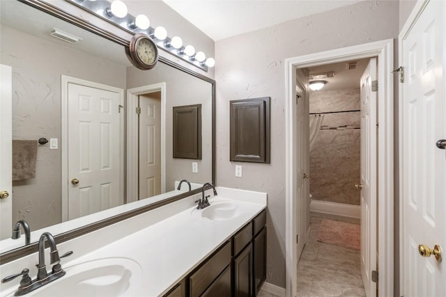 full bathroom featuring double vanity, visible vents, shower / bath combo with shower curtain, and a sink