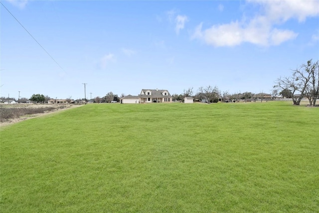 view of yard with a rural view