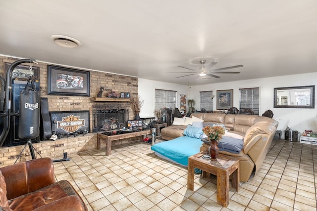 tiled living area with ceiling fan and a brick fireplace