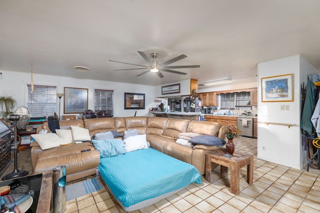 living area with light tile patterned flooring and ceiling fan