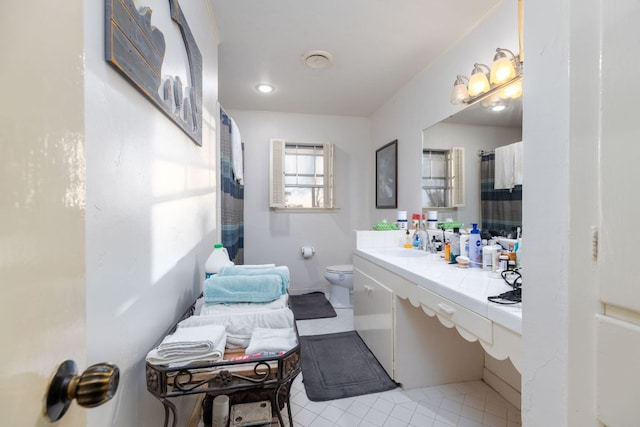 bathroom featuring toilet, vanity, and a shower with curtain