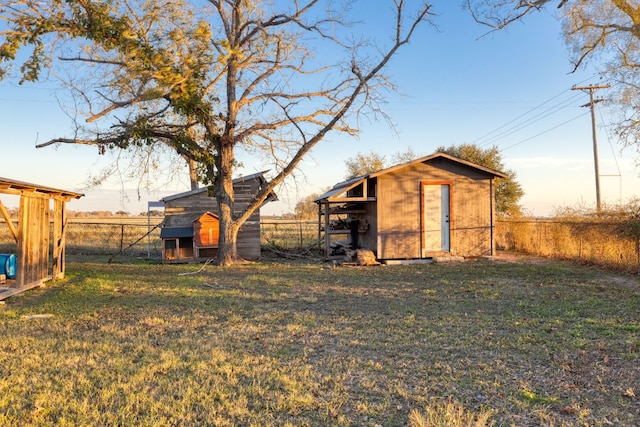 view of outbuilding featuring an outdoor structure and fence