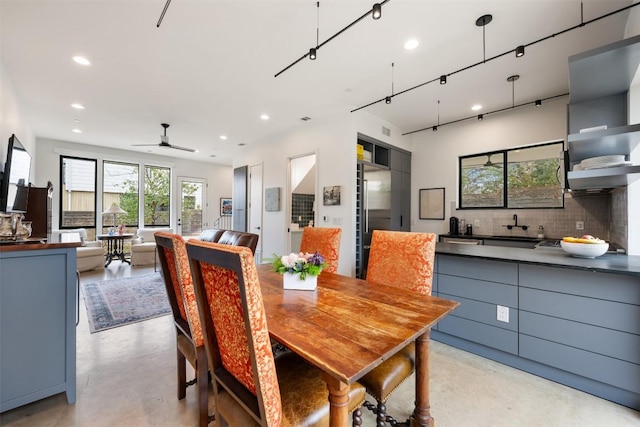 dining space featuring concrete floors, a ceiling fan, and recessed lighting