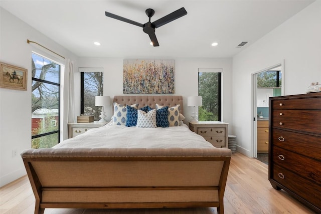 bedroom featuring light wood-type flooring, multiple windows, and visible vents