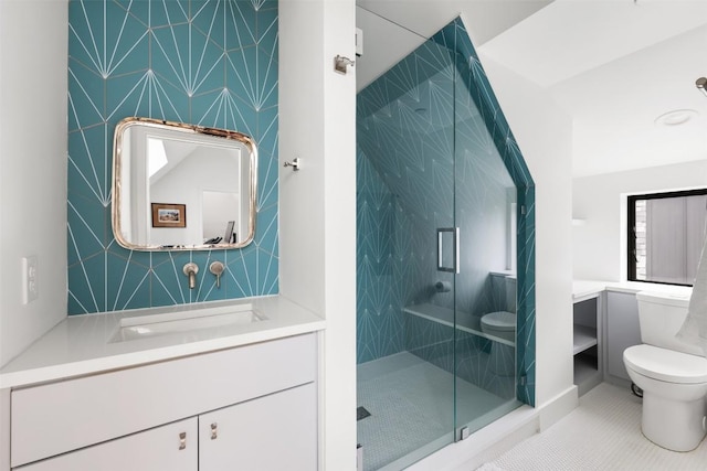 full bathroom with a stall shower, vanity, toilet, and tile patterned floors