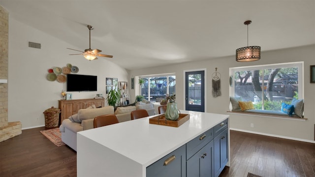 kitchen with visible vents, lofted ceiling, open floor plan, light countertops, and pendant lighting