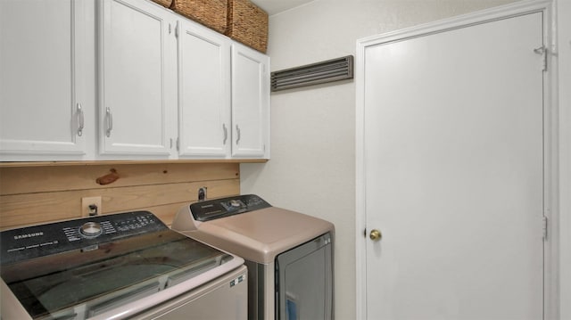 washroom featuring cabinet space and washer and dryer