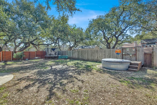 view of yard with a fenced backyard and a trampoline