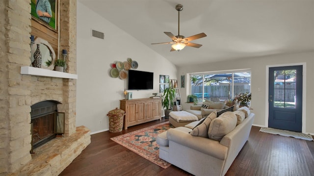 living room featuring dark wood-style flooring, a fireplace, visible vents, a ceiling fan, and high vaulted ceiling