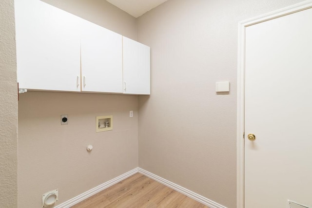 8507 Chat Ln, Round Rock, TX 78681 - laundry room with gas dryer hookup, hookup for an electric dryer, light wood-style floors, washer hookup, and cabinet space