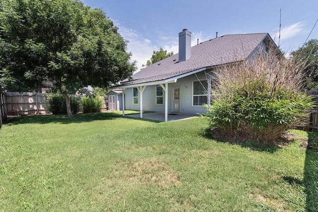 8507 Chat Ln, Round Rock, TX 78681 - rear view of house with a patio, a storage shed, a chimney, and roof with shingles