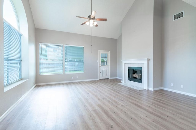 8507 Chat Ln, Round Rock, TX 78681 - unfurnished living room featuring ceiling fan, high vaulted ceiling, light wood-style flooring, and a tile fireplace