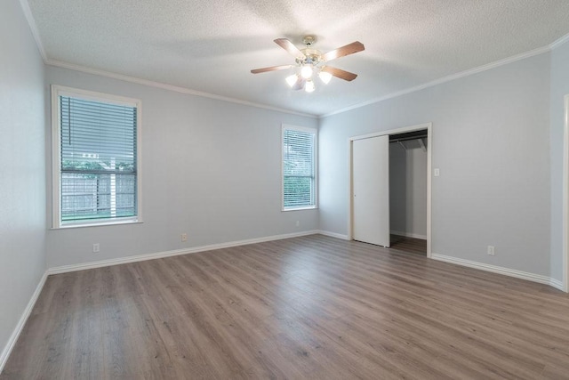 8507 Chat Ln, Round Rock, TX 78681 - unfurnished bedroom with wood finished floors, a textured ceiling, ornamental molding, a closet, and ceiling fan