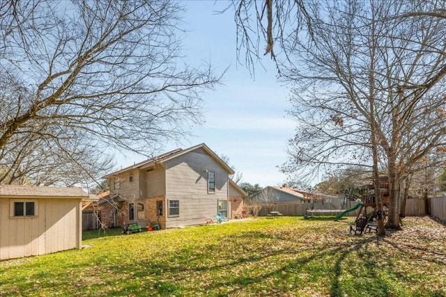 exterior space featuring a playground, a lawn, and a fenced backyard