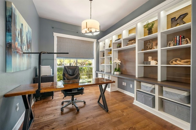 office area with wood finished floors and baseboards