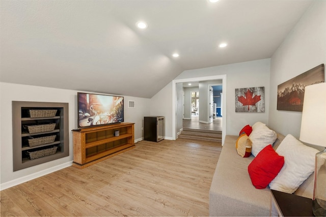 living area with recessed lighting, baseboards, vaulted ceiling, built in features, and light wood-type flooring