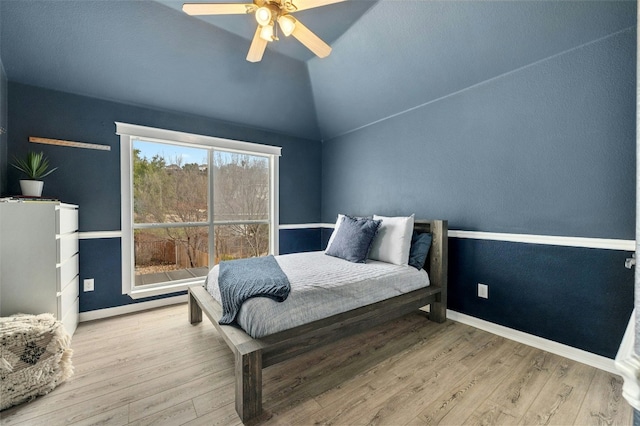 bedroom featuring lofted ceiling, light wood finished floors, ceiling fan, and baseboards