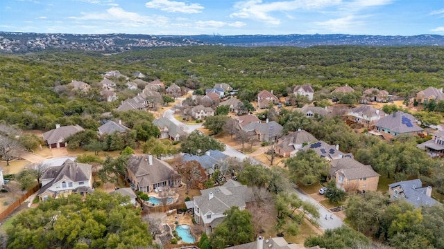 drone / aerial view featuring a residential view and a view of trees