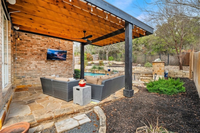 view of patio / terrace with a fenced backyard, an outdoor living space, and a ceiling fan