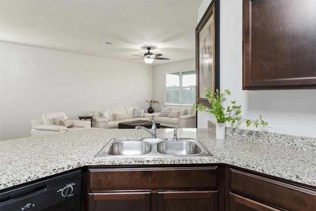 kitchen featuring dishwasher, light countertops, a sink, and open floor plan