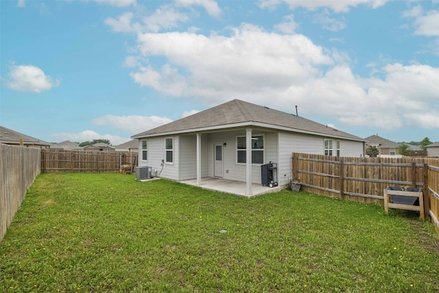 rear view of property with a patio area, a lawn, a fenced backyard, and central AC unit