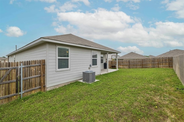 view of yard with central AC and a fenced backyard