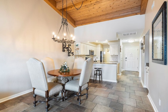 dining area featuring baseboards, visible vents, wooden ceiling, an inviting chandelier, and stone finish flooring