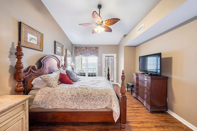 bedroom featuring light wood-type flooring, visible vents, vaulted ceiling, and baseboards