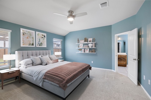 bedroom featuring lofted ceiling, light colored carpet, visible vents, a ceiling fan, and baseboards