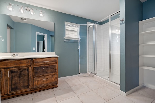 full bathroom featuring a stall shower, visible vents, vanity, and tile patterned floors