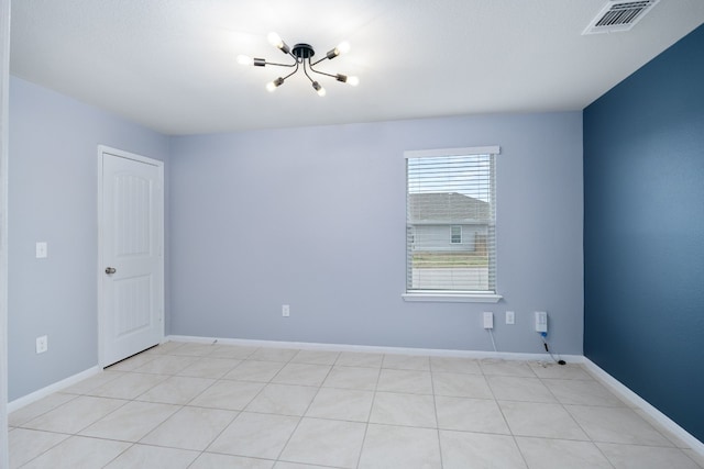 unfurnished room featuring baseboards and visible vents