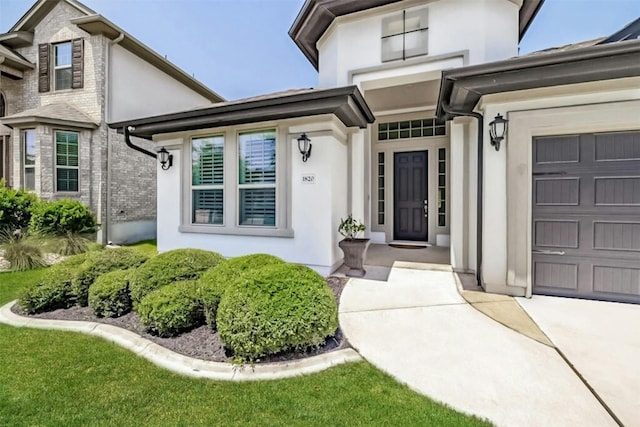 1820 Ficuzza Way, Leander, TX 78641 - entrance to property featuring stucco siding, a garage, and driveway