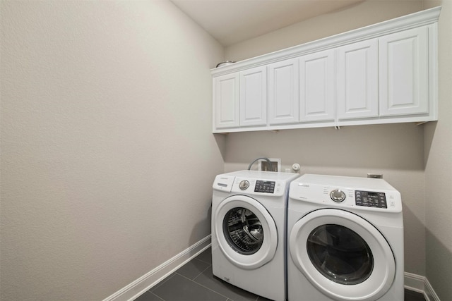 1820 Ficuzza Way, Leander, TX 78641 - laundry room featuring separate washer and dryer, cabinet space, baseboards, and dark tile patterned flooring