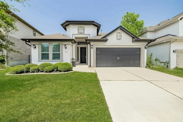 view of front of home with a garage, stucco siding, driveway, and a front yard