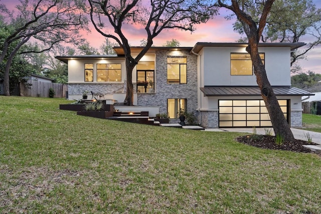 4907 Timberline Dr, Austin, TX 78746 - view of front facade with stone siding, an attached garage, a standing seam roof, stucco siding, and driveway