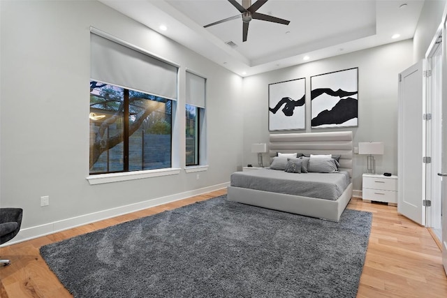 4907 Timberline Dr, Austin, TX 78746 - bedroom with light wood-style floors, recessed lighting, a raised ceiling, ceiling fan, and baseboards