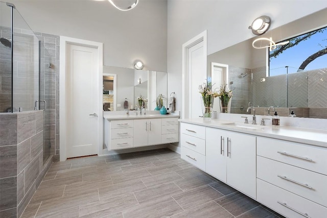 4907 Timberline Dr, Austin, TX 78746 - bathroom featuring a shower stall, two vanities, and wood tiled floors