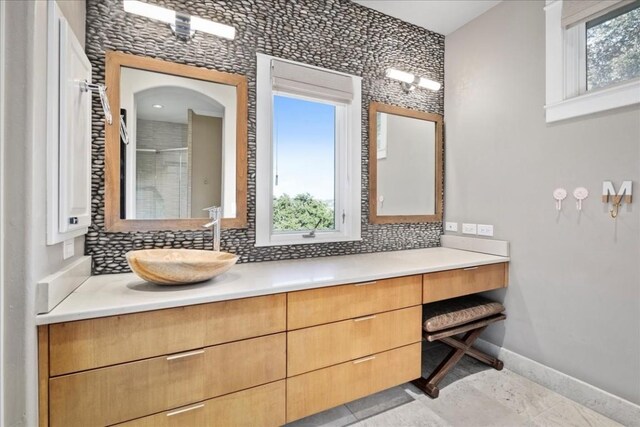 15210 Rainbow One St, Austin, TX 78734 - bathroom with decorative backsplash, baseboards, vanity, and a shower