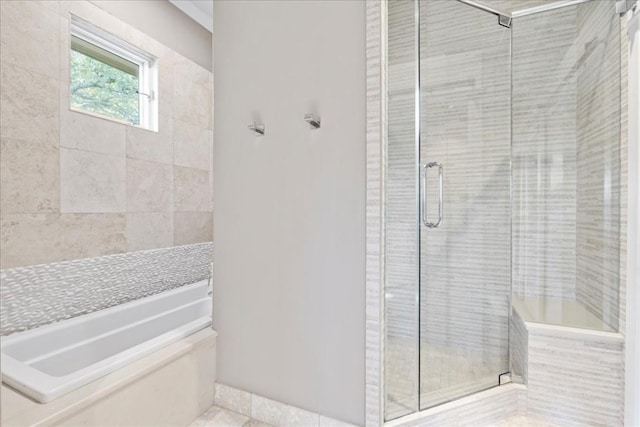 bathroom featuring a stall shower and a garden tub